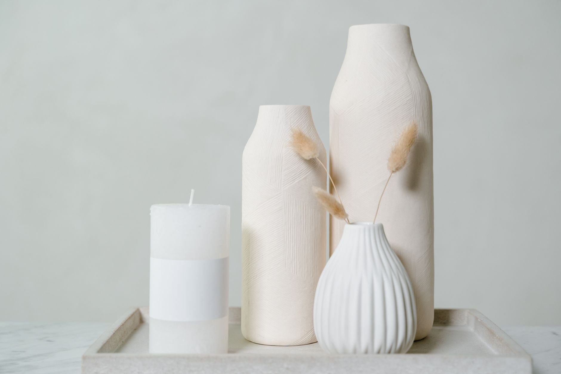 Elegant still life with ceramic vases and a candle in minimalist warm style